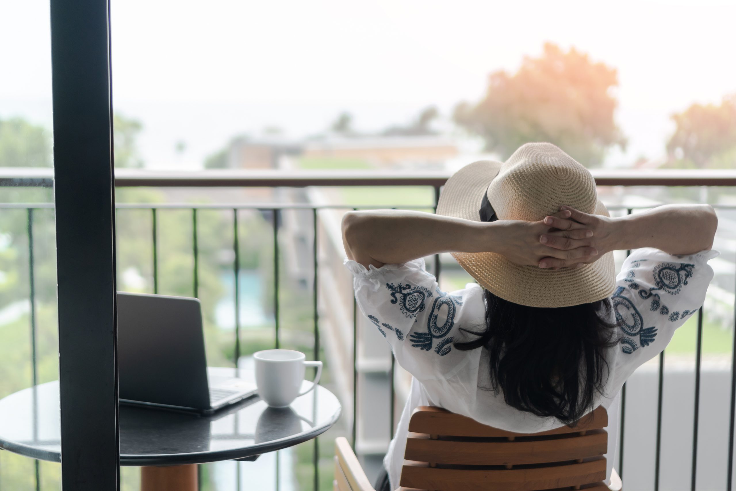 Work-Life balance, life quality, work from home and travel concept with business woman relaxing, take it easy, resting in  hotel resort, condominium, or apartment luxury living room with notebook